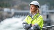© Andrii  - Female Engineer in High-Visibility Jacket at Hydropower Plant