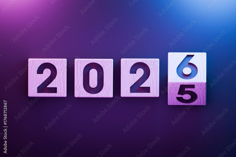 Wooden blocks showing the transition from 2025 to 2026 with pink and ...