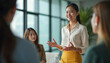 © Maryna - Asian businesswoman leads team meeting in modern office. Female speaker shares ideas, colleagues listen attentively. Group collaborates on project, discusses strategy.