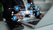 © InfiniteFlow - A focused businesswoman uses a laptop to strategize success and goal setting, featuring a target icon in a modern corporate workspace that emphasizes perseverance. Tessel