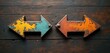 © Maryna - Two rusty metal arrows point in opposite directions on a weathered wooden surface. One arrow is yellow and blue the other orange and brown. This visual represents choice and divergence.