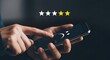 © Gennyson Marinho - Frustrated customer gives low star rating on mobile device experiencing service issues or product dissatisfaction