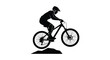 © AL-AMIN - Dynamic silhouette of a mountain biker performing a jump over an obstacle on a trail
