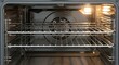 © photoplotnikov - Interior of clean stainless steel electric oven with light on