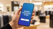 © HerlinaWidyastuti - Hand holding smartphone with secret discount code on screen in clothing store