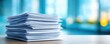 © Tin - Detailed view of neatly stacked official papers concept. A stack of papers on a wooden desk in an office environment.