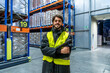 © unai - Worker smiling in cold storage warehouse inspecting inventory
