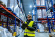 © unai - Woman working in cold storage logistics warehouse checking inventory