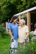 © Halfpoint - Home nurse spending time with elderly lady patient in garden.