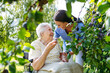 © Halfpoint - Home nurse spending time with elderly lady patient in garden.