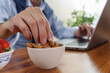 © Lomb - Enjoying a healthy snack while working at home with laptops and fresh fruits on the table