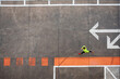 © VISTA by Westend61 - Runner in neon shirt seen from above on urban concrete sports area