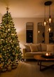 © Creative Parul  - Cozy living room decorated for christmas with a beautifully lit tree, comfortable sofa, and warm ambient lighting, creating a festive holiday atmosphere