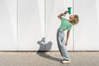 © VISTA by Westend61 - Young woman bending backwards and speaking through megaphone