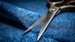 © Anastasiia - Close-up of a pair of metal scissors resting on blue denim fabric. Concept Close-up of metal scissors, Blue denim texture, Crafting tools, Industrial photography, Sharp blades on fabric