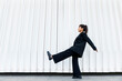 © VISTA by Westend61 - Businesswoman strikes aesthetic pose in front of modern architecture