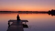 © Vlad - Minnesota Dock. Sunset Silhouette of Woman Fishing on Calm Lake Shore