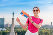 © EdNurg - Happy tourist holding a Serbian flag and Belgrade skyline in the background