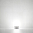 © Алексей Доненко - This minimalist image features a simple white lamp emitting a soft glow against a clean white wall. The lamp serves as a focal point, radiating light that brightens the empty space. The gentle illumin