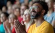 © Yuliia - Excited spectator in yellow t-shirt and glasses showing genuine emotion while watching sports event or performance in crowded stadium. Authentic fan experience.