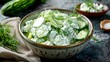 © RanaMuhammad - A bowl of tzatziki salad with fresh cucumber and dill on a wooden surface in a close up shot