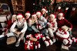 © deagreez - Family group celebrates Christmas together with gifts around a decorated tree in a cozy home setting