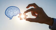 © Kreatif Studio - Hand Placing Puzzle Piece into Brain Outline for Problem Solving