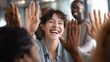 © TanaGera - Diverse team of young IT professionals celebrating successful project launch in modern office, laughing woman giving high-five with expressive focal point, successful collaboration team achievement
