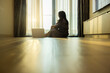© shine - Good looking middle aged woman with laptop sitting on floor lets sunlight into living room on morning in modern, enjoy carefree rest and optimistic mood. Wealthy house. Well-being. Space for text
