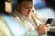 © Marko Geber - Middle aged man using smartphone in car