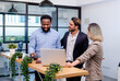 © PINA - team of multiethnic colleague discuss business topic in creative green office co working space, group of business people coworker casual online meeting on laptop standing desk modern office workplace