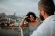 © Halfpoint - Real estate agent talking to female client on the rooftop of a modern building