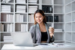 © Katcha - Accounting business concept, Accountant woman drinking coffee and typing data on laptop while working