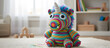 © SandaRina - Colorful crocheted unicorn toy in a bright room with wooden blocks during daytime