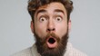 © Johannes - close up shot of emotive shocked bearded young male opens mouth widely stare at camera points upwards aside at blank space says wow its something unbelievable people and emotions concept no logos no