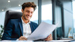 © somegirl - Young business man working looking papers data results happy successful office