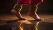 © Irina - Bridal dancer's feet adorned with ghungroo in traditional Indian wedding performance with reflection and warm light