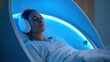 © MarinkaLev - Person resting in a futuristic wellness pod, brain activity monitored via neural interface, calm lighting and soft ambient tech glow