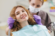 © Parilov - Female adult caucasian patient receiving dental checkup from female dentist
