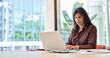 © Stock 4 You - Young professional specialist latin hispanic business lady working on laptop pc at desk in modern office space. Middle eastern woman using computer technology app for work online. Banner, copy space