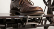 © ManuStockStudio - Vintage sewing machine foot pedal close up leather