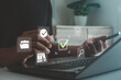 © MUNTHITA - Businessman using smartphone and laptop with digital checklist icons, data management, online document approval and cybersecurity concept for business technology and workflow efficiency.