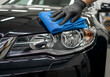 © Dostain - Car detailing - the man holds the microfiber in hand and polishes the car
