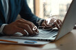 © Luke - Professional Businessman Engaging with Technology while Using Laptop in Modern Office Environment with Graphics Overlay Representing Connectivity and Data