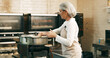 © peopleimages.com - Bakery, woman and frying donuts in kitchen for small business order, baking process and catering. Hospitality industry, baker and dessert preparation in restaurant with culinary skills and gastronomy