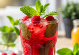 Refreshing raspberry mojito cocktail with mint garnish offers vibrant summer refreshment