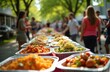 © Maryna - Neighborhood block party event gathers many people outdoors. Long table filled with various colorful dishes in foil pans. Guests share meal, mingle, socialize, enjoy warm summer day. Friends eat, fun