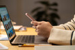 © Studio Marmellata - Side view of crop anonymous female freelancer using mobile phone and laptop while working from home in evening