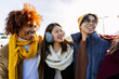 © Xavier Lorenzo - Diverse group of gen z happy friends having fun together on winter vacation. Multicultural teenage people laughing outdoors. Friendship concept
