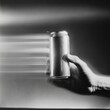 © Belvedere studio - Hand holds a can in motion creating a dynamic effect indoors during a creative photography session